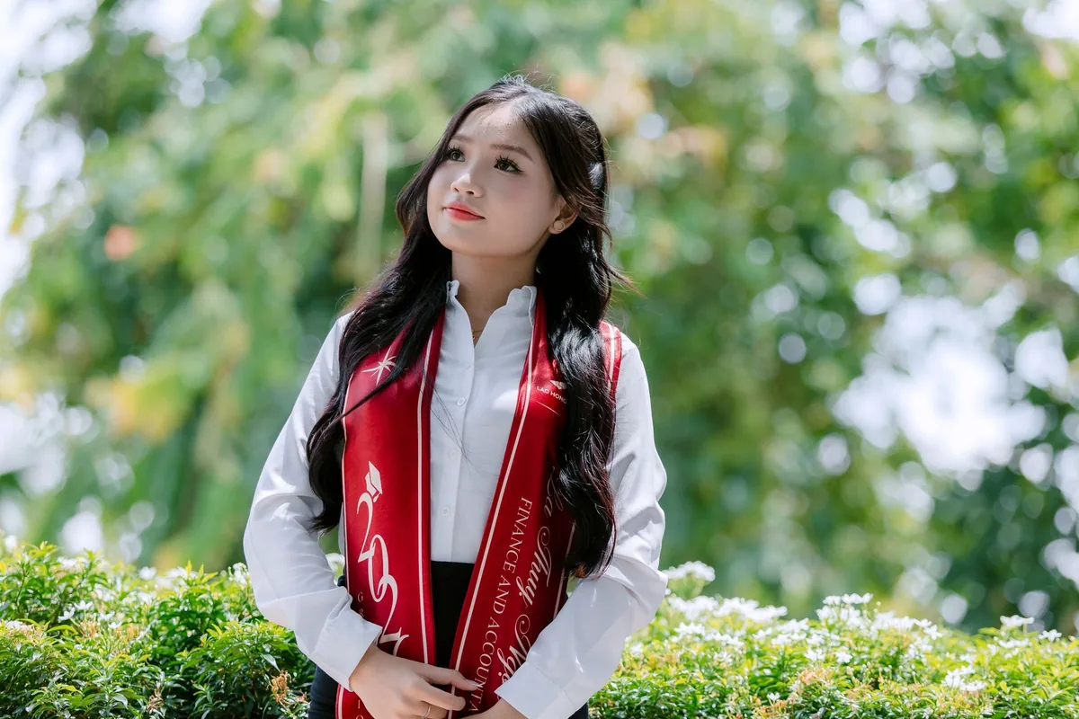 A graduate celebrating an achievement outdoors.